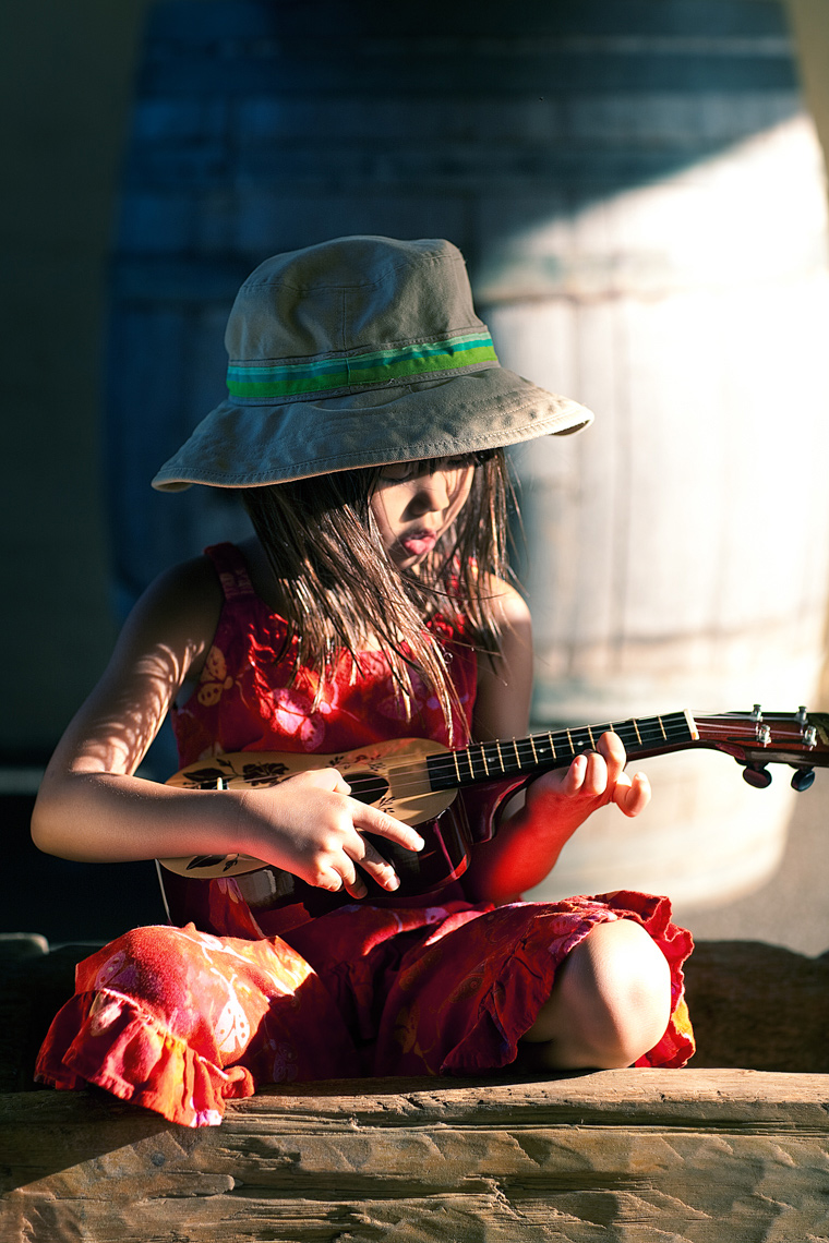 Young girl playing ukulele Portrait by commercial celebrity photographer Michael Grecco 